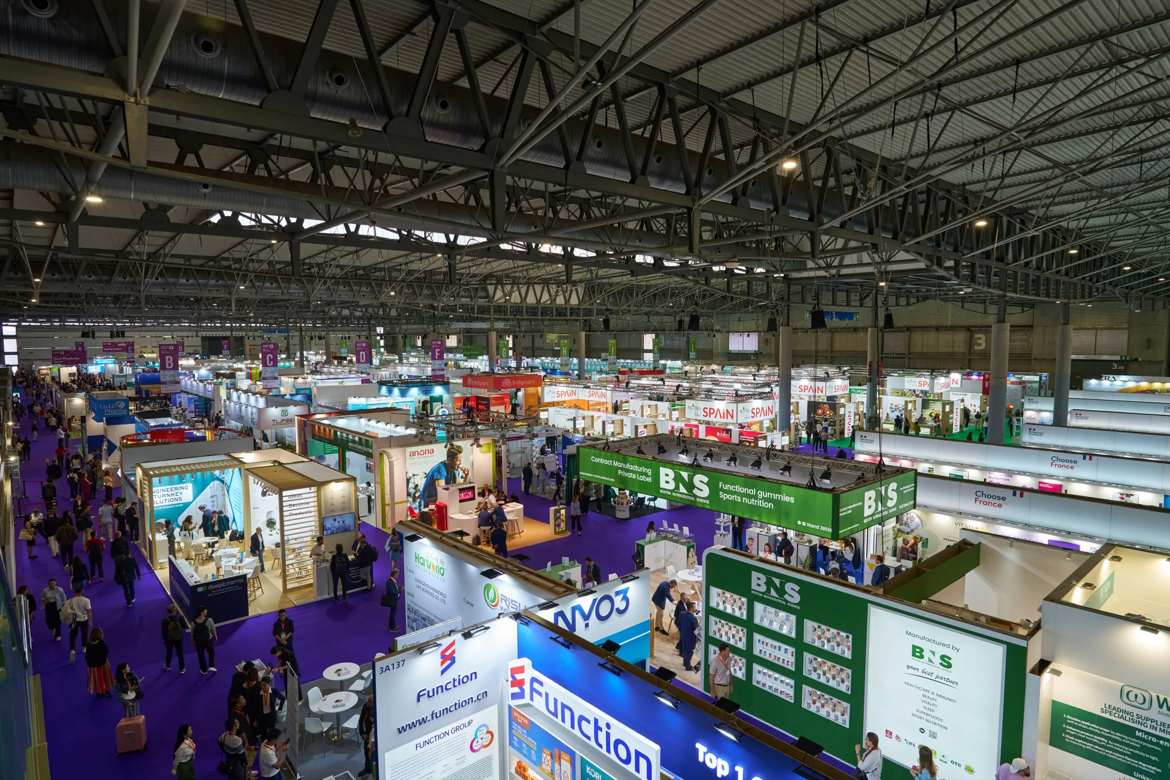 Exhibition hall filled with booths and visitors